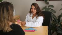 Hoosna Haque, MD, meets with patient in her office